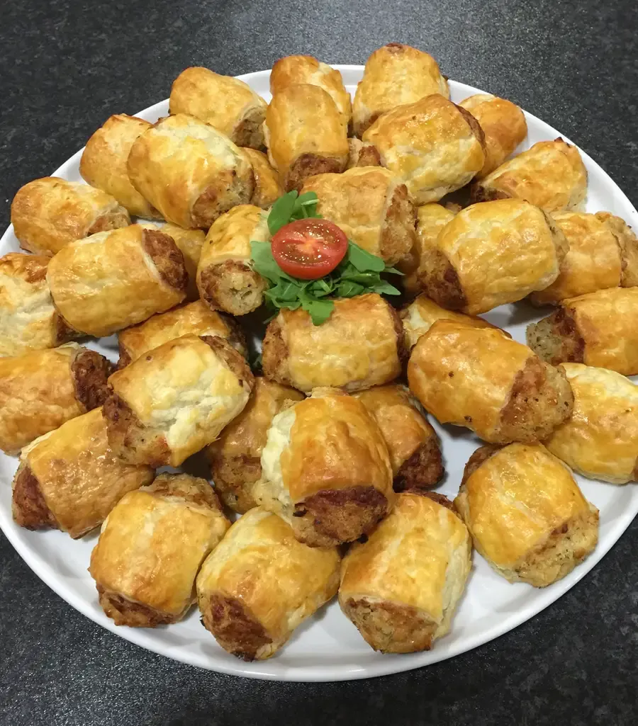 A plate of freshly baked sausage rolls
